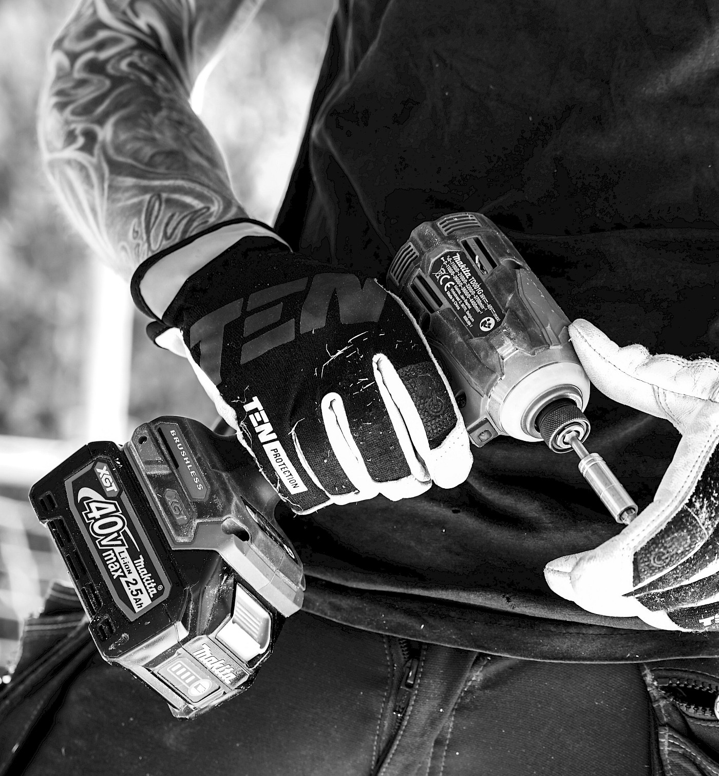 Black and white photo man holding a drill